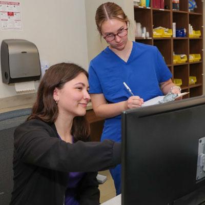 two students work at a computer